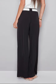 woman wearing a black pat with white shash belt 