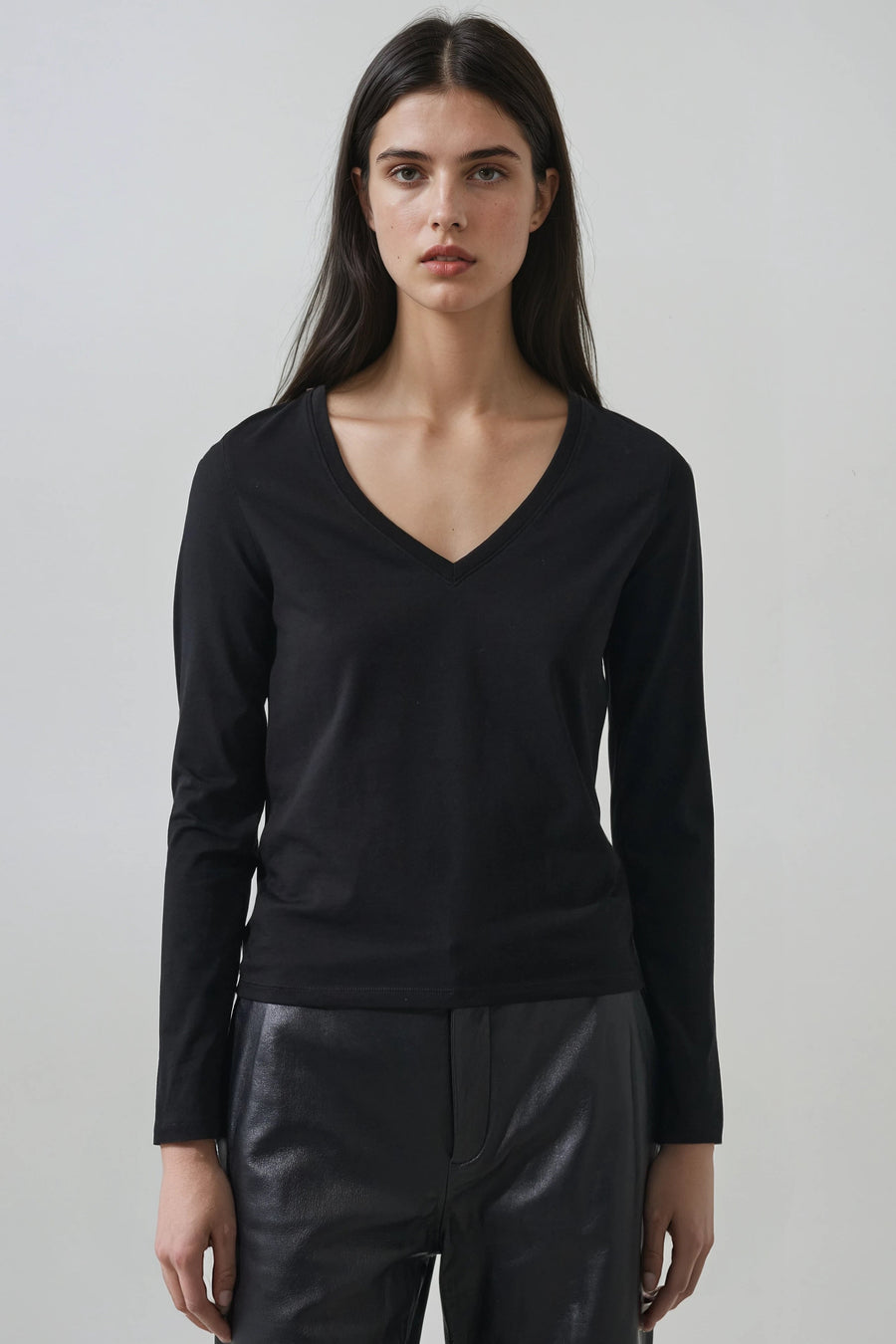 model wearing black v neck long sleeve t shirt with relaxed fit 