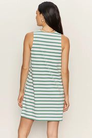 Woman wearing a sleeveless white shift dress with soft sage green horizontal stripes. The dress features a high crew neckline, an easy A-line silhouette, and falls above the knee, back