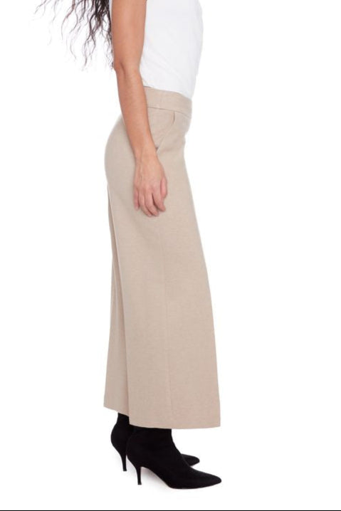Beige wide-leg pants worn by a person on a white background