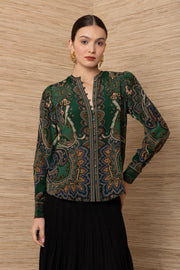 women wearing a green button up blouse with gold and blue floral designs with a structured fit 