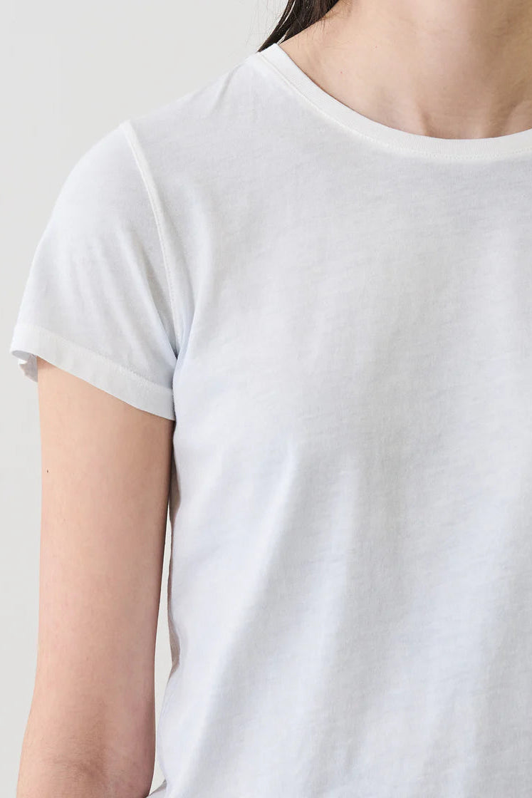 Woman wearing a light blue short-sleeve crewneck T-shirt, detail view