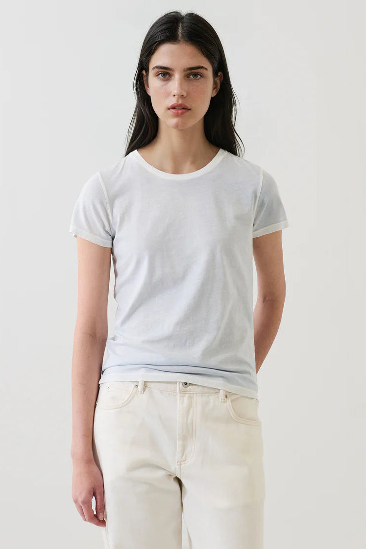 Woman wearing a light blue short-sleeve crewneck T-shirt, front view