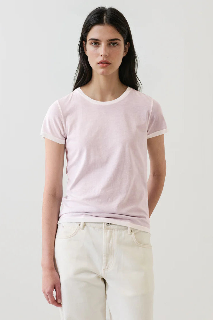 Woman wearing a light pink short-sleeve crewneck  T-shirt 