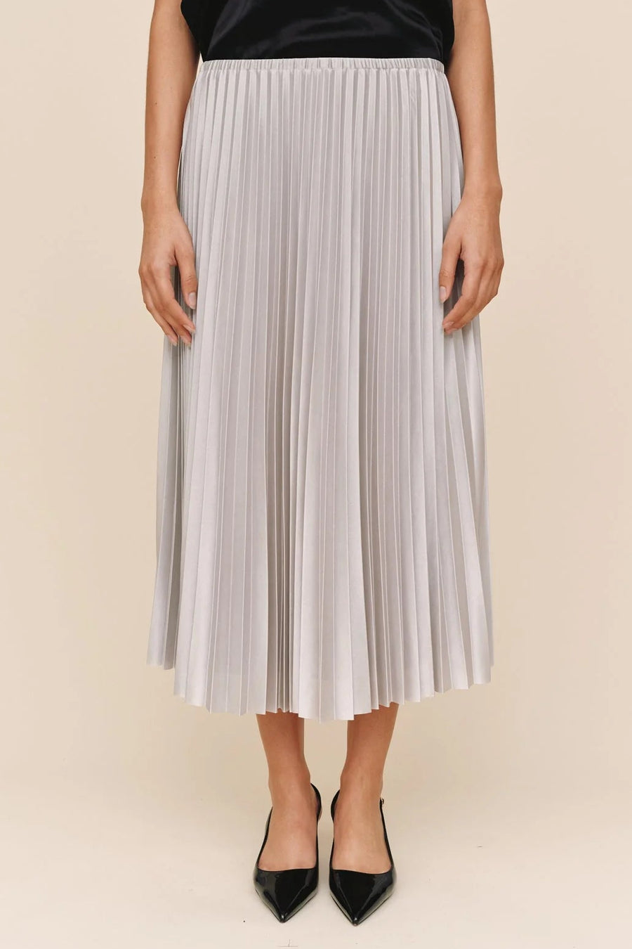 woman wearing a pleated silver skirt