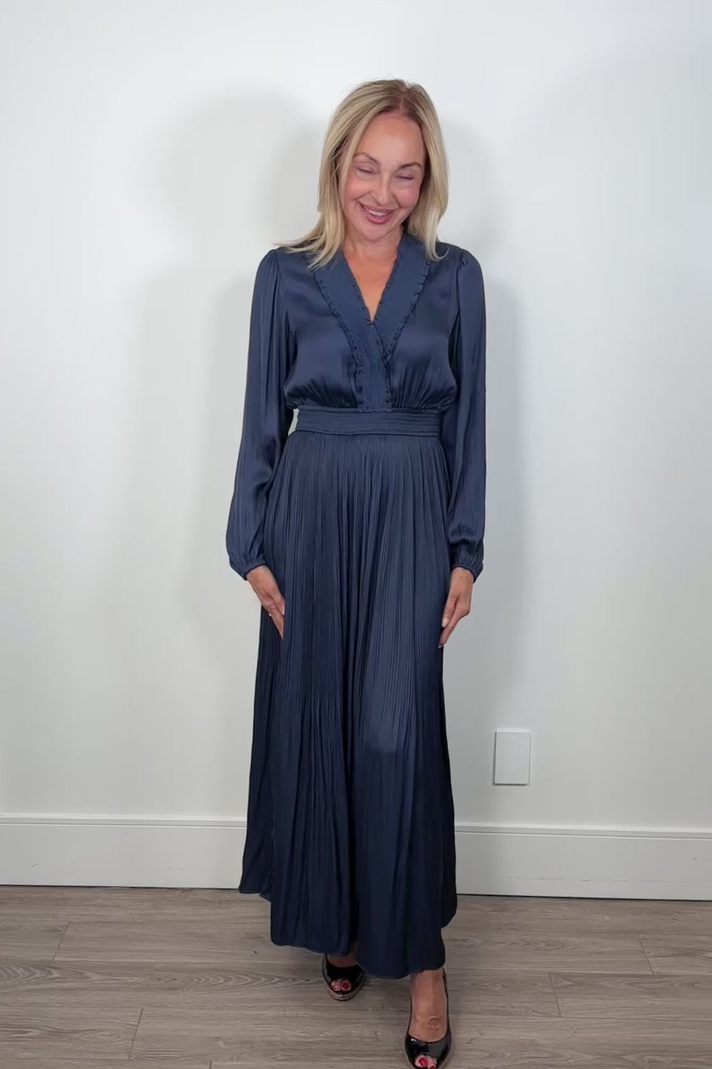 Video of woman wearing a blue maxi long sleeve silk dress