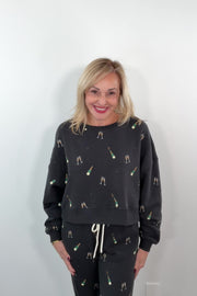 video of woman wearing a black sweatshirt with champagne bottle print 