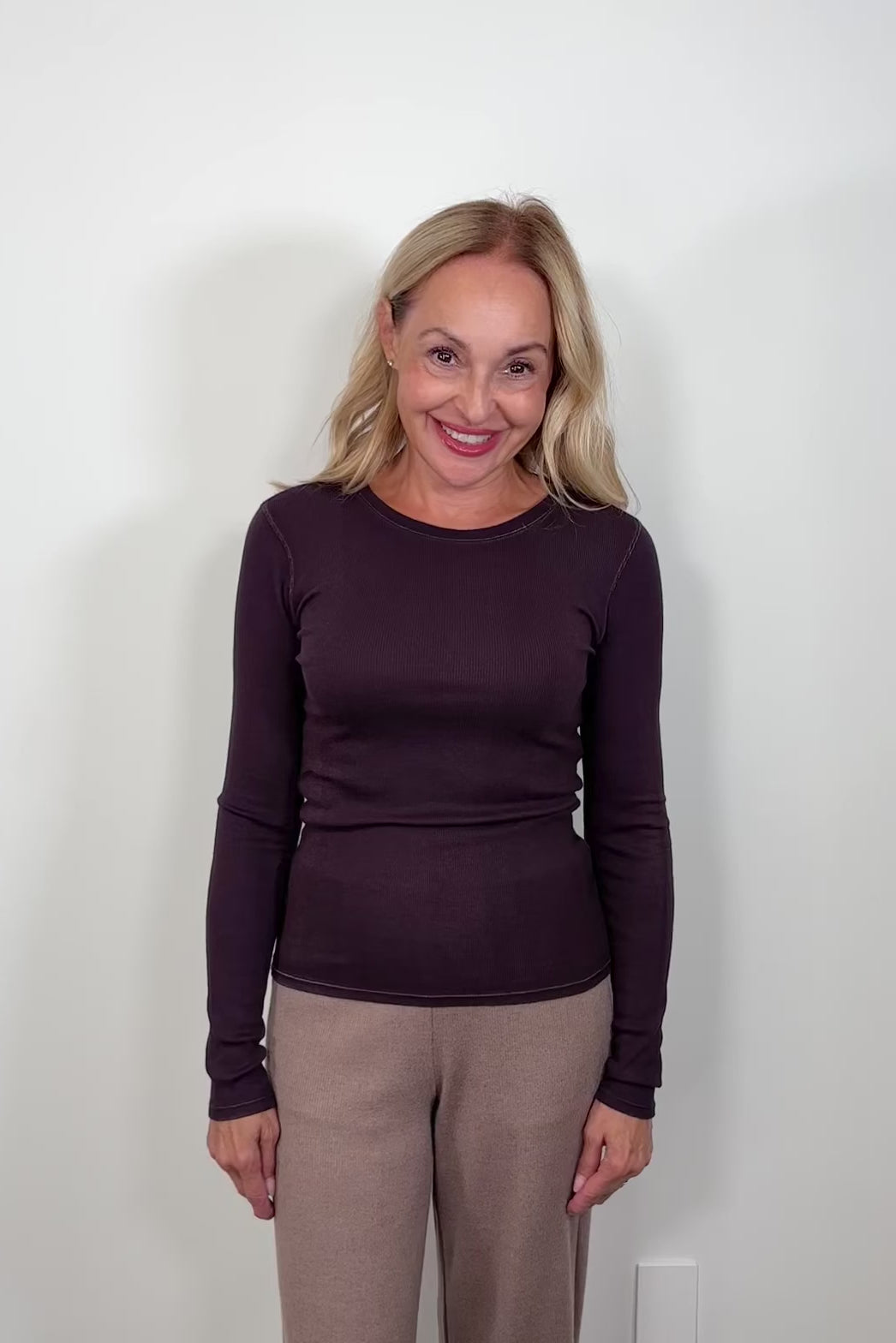 Video of a woman wearing a long-sleeve dark purple rev spray v-neck tee