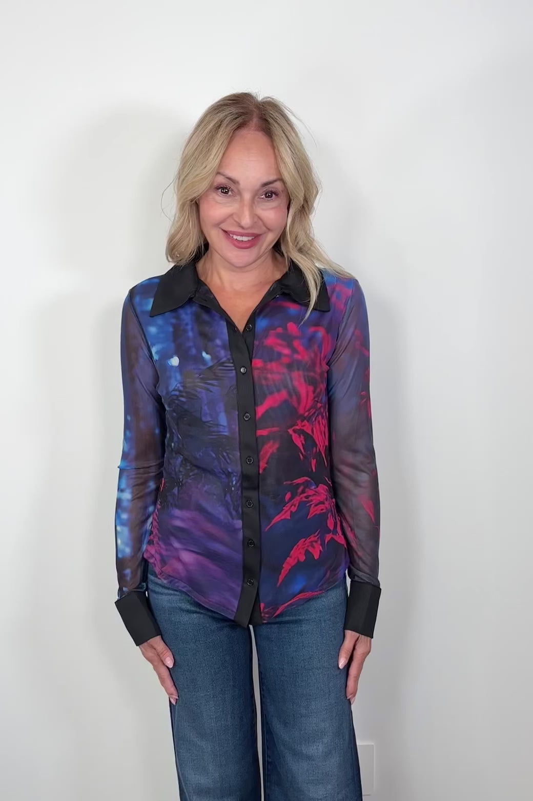 Video of a woman wearing a blue and red long sleeve mesh shirt