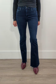 video of a woman wearing frayed dark blue jeans 