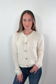 video of a woman wearing a cream cardigan