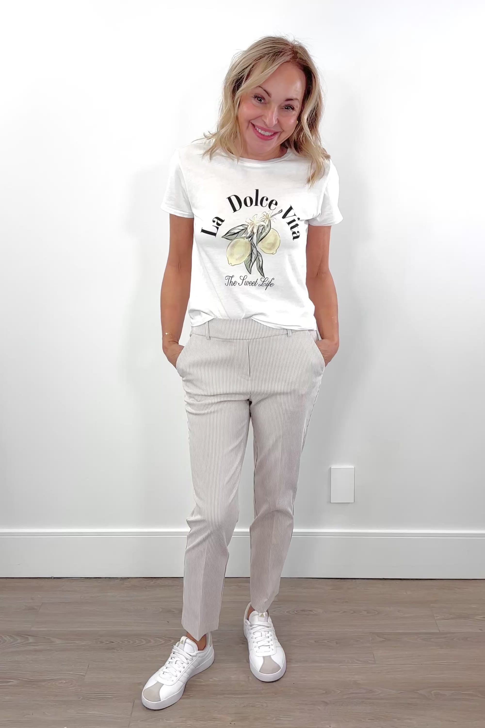 Video of woman wearing an ankle length beige stripped pants
