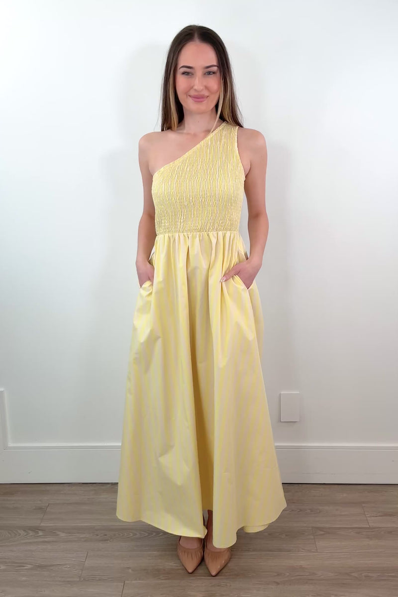 video of a woman wearing a one-shoulder elastic torso yellow and white stripped dress
