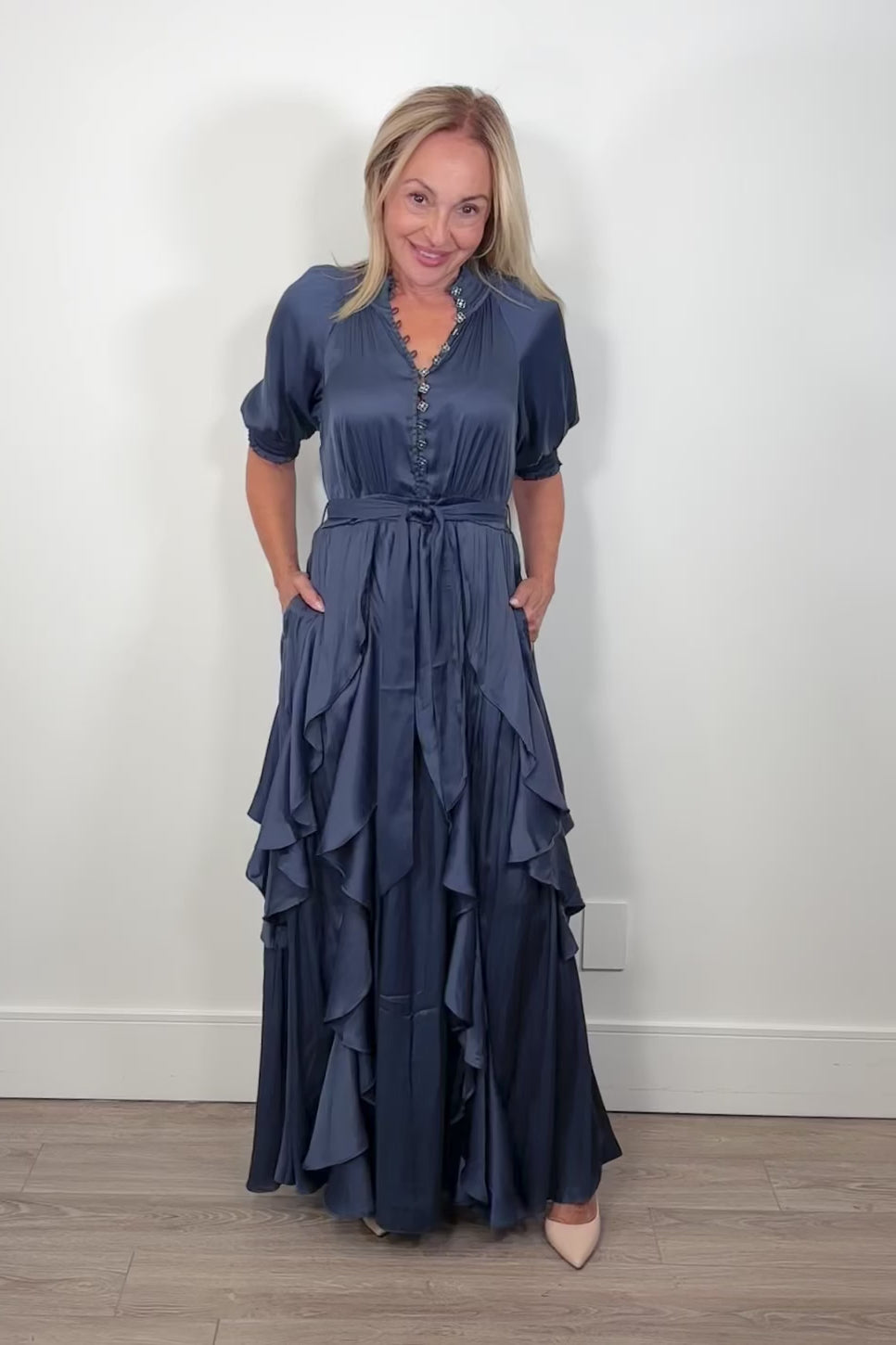 Video of woman wearing a maxi dress with ruffles