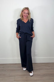 Video of a woman wearing navy blue drawstring pants