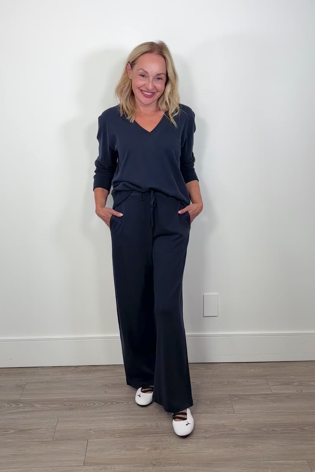 Video of a woman wearing navy blue drawstring pants