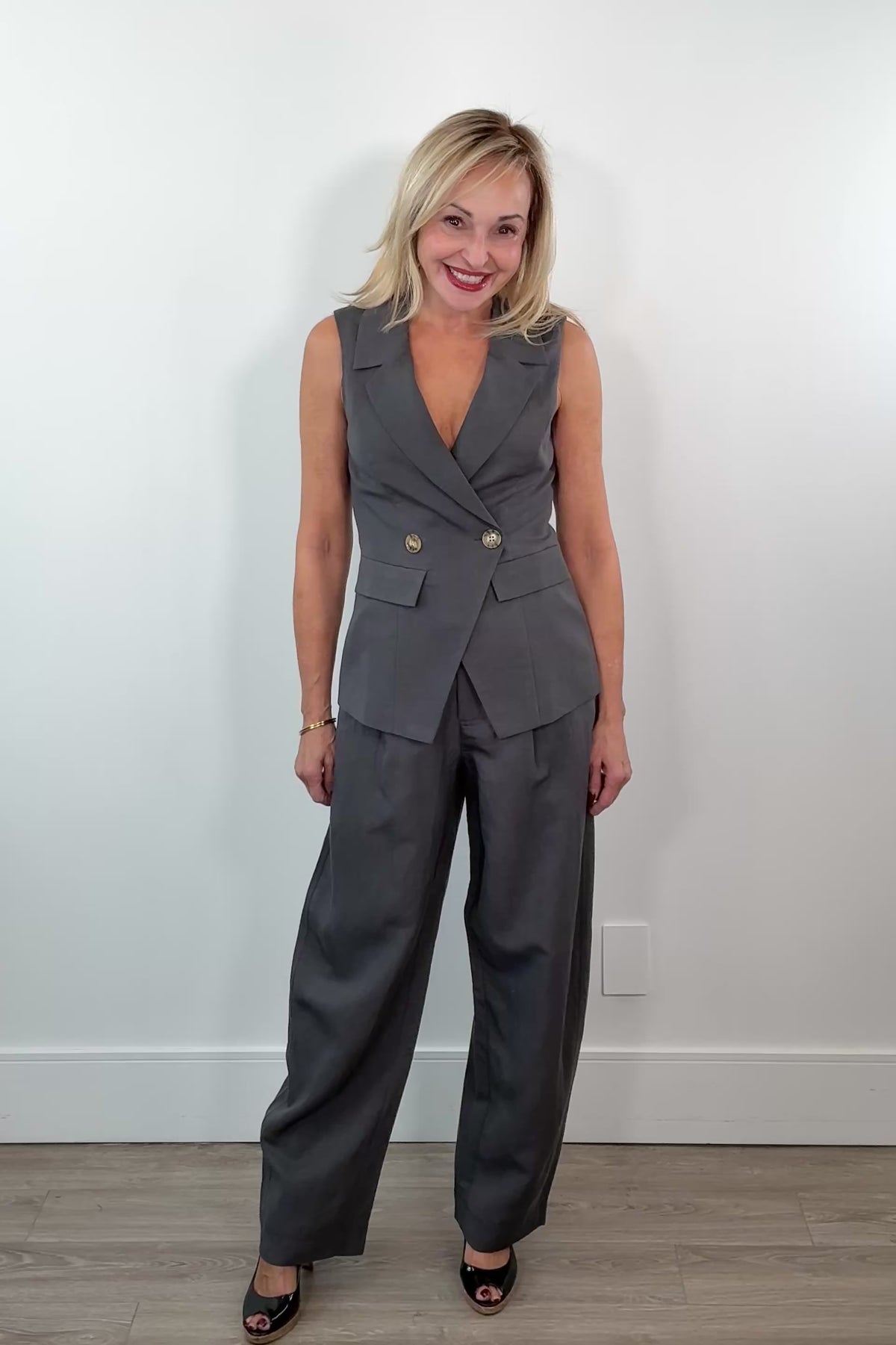 Video of Woman wearing wide leg grey dress pants