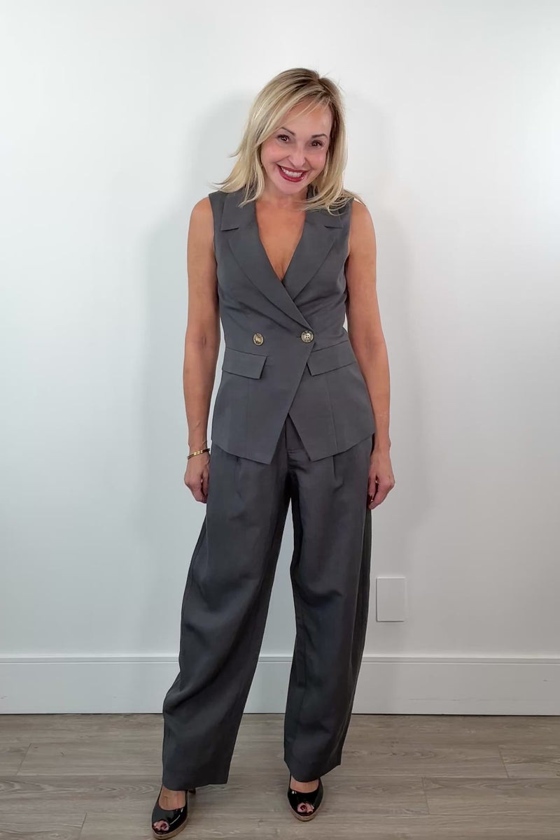 Video of Woman wearing wide leg grey dress pants