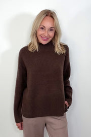 Video of woman wearing an oversized cashmere brown sweater