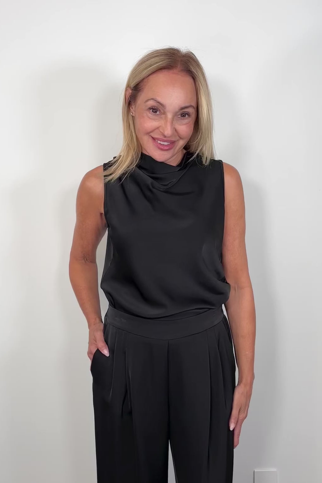 Video of woman wearing a satin sleeveless top