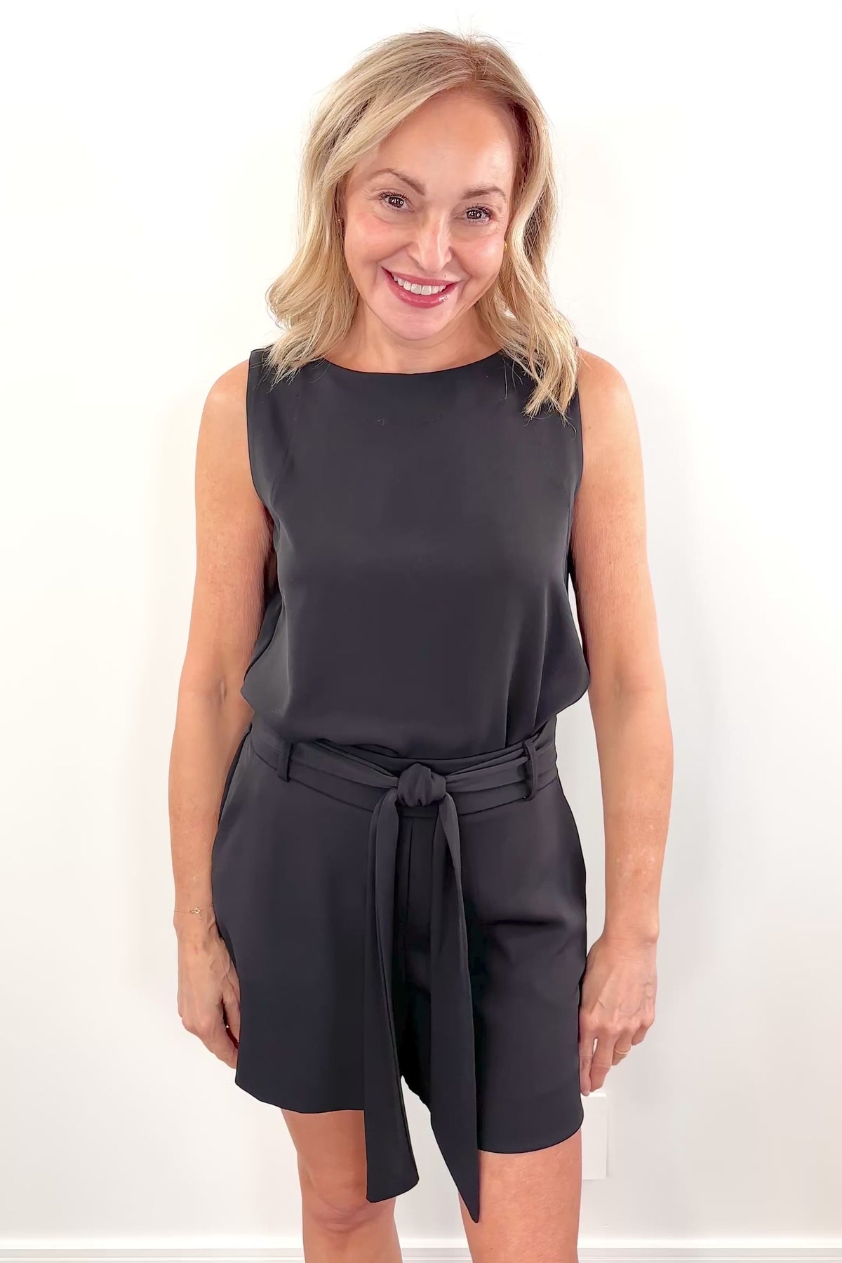 Video of woman wearing sleeveless vegan silk black top