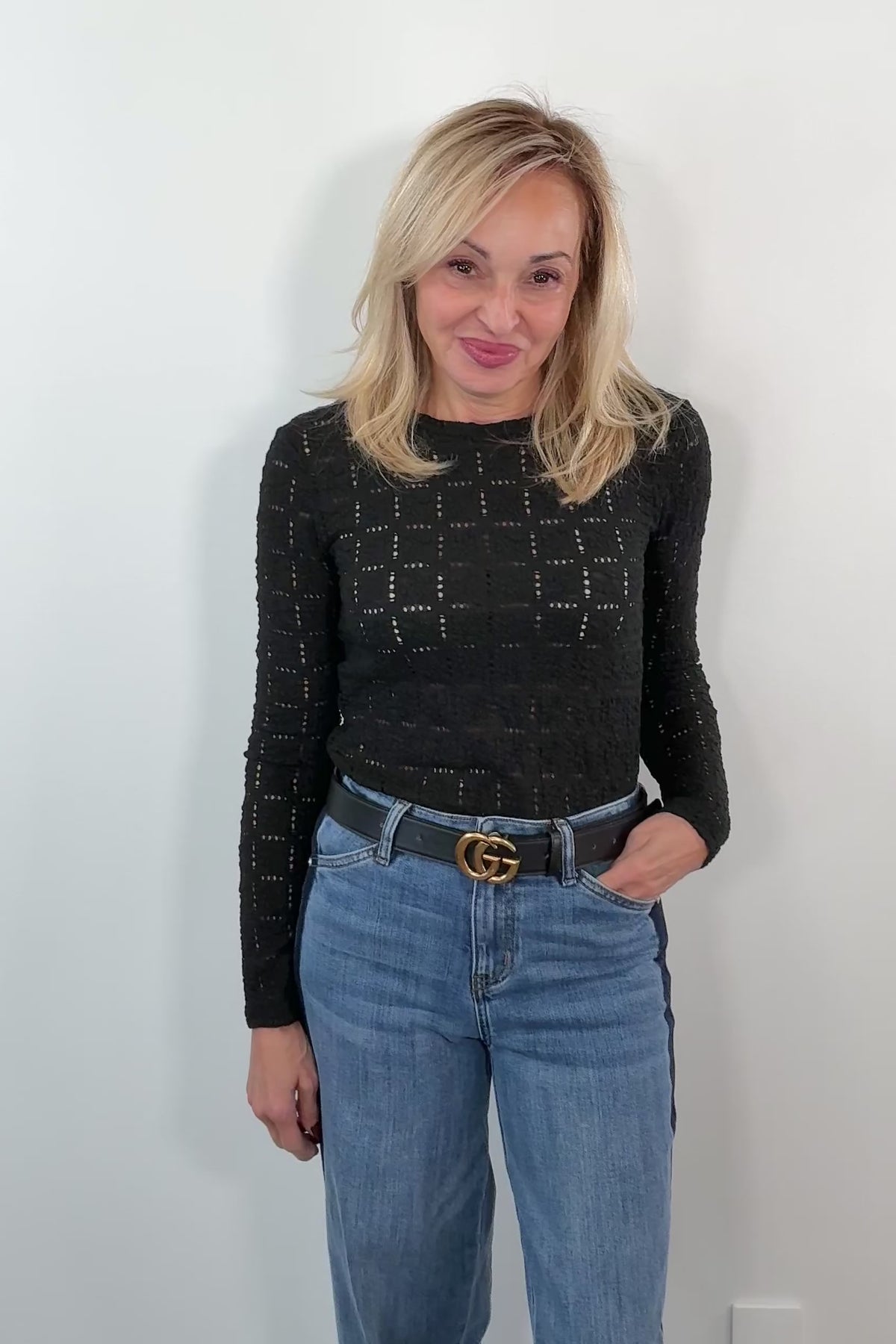 video of a woman wearing a black patterned long sleeve tee