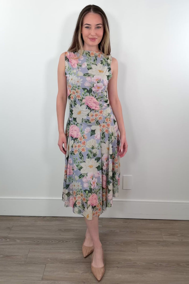 Video of a woman wearing a floral print sleeveless midi asymmetrical dress 