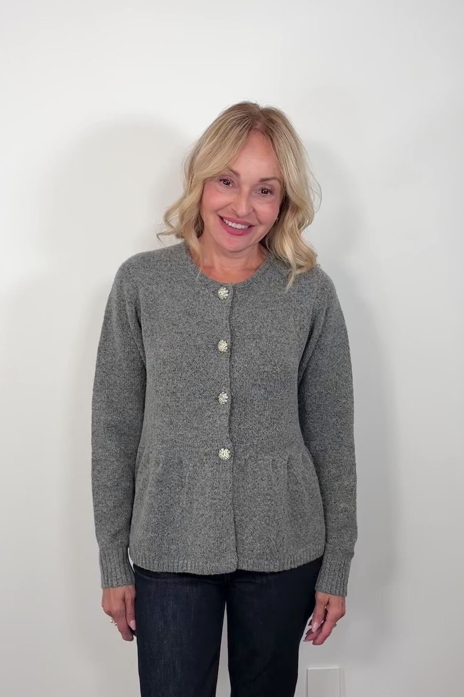 video if a woman wearing a gray  peplum cardigan