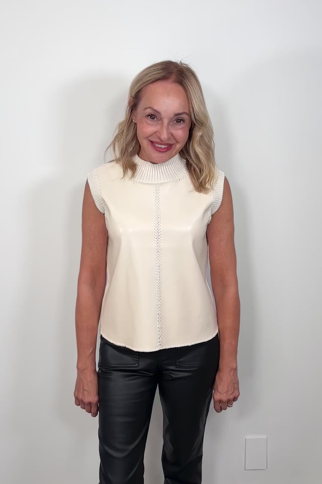 Video of a woman wearing a sleeveless mix media tank top