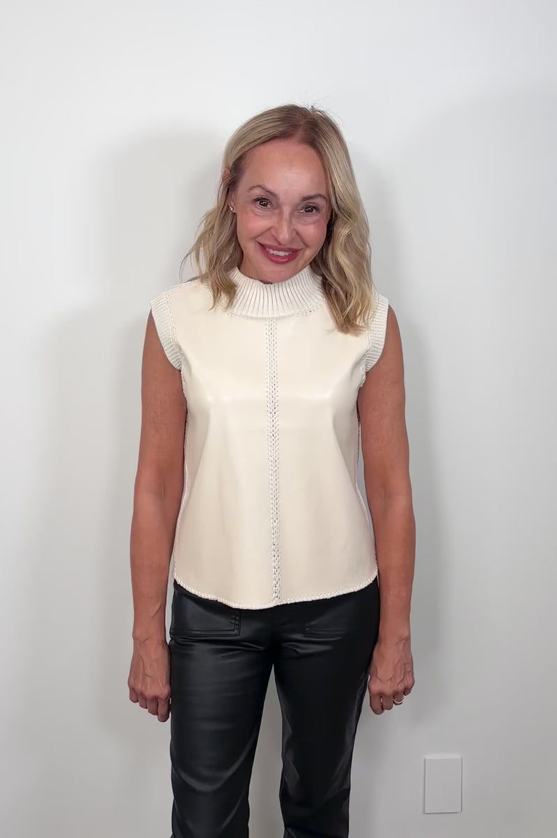 Video of a woman wearing a sleeveless mix media tank top