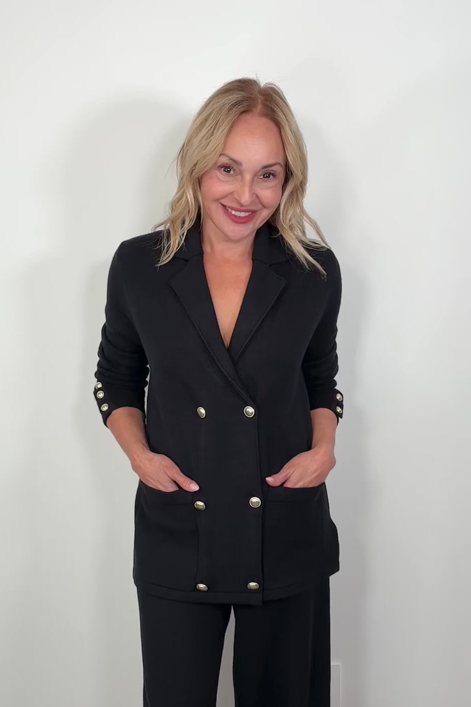 Video of a woman wearing a black sweater blazer