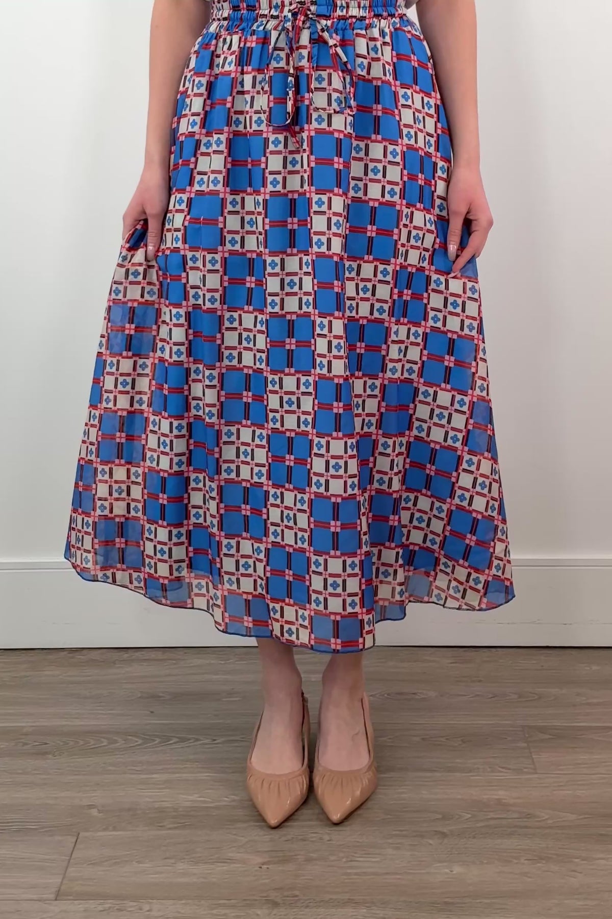 video of a woman wearing an azulejos patterned midi skirt 