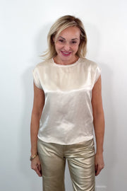 video of a woman wearing a cream satin cap sleeved top