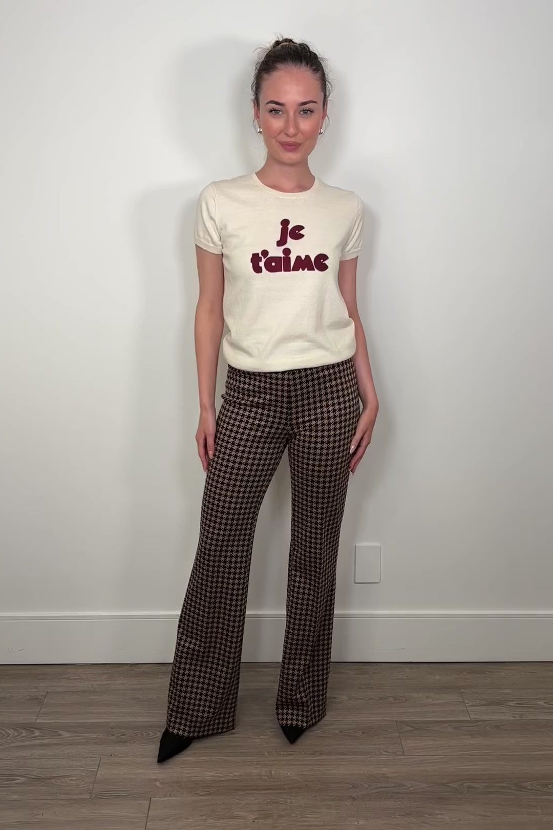 Video of woman wearing a houndstooth knit pant