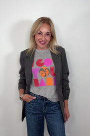 Video of woman wearing a gray sleeveless tee with “I got you babe” graphic words printed paired with a dark gray blazer with rhinestones, turning around to show the back