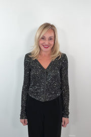 video of a woman wearing a snap on black sequin cardigan