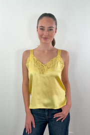 video of woman wearing a gold satin lace trim tank top