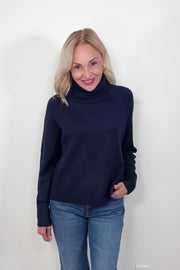 Video of woman wearing an oversized Navy knitted turtleneck 