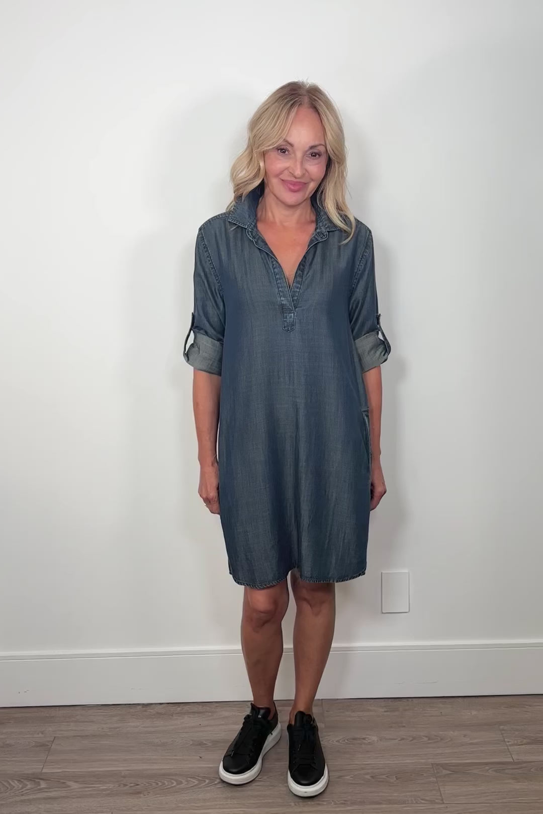 Video of woman wearing a blue midi tencel yoke dress with cuffed sleeves 