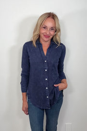 Video of a woman wearing a washed blue button down shirt