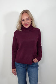 Video of woman wearing an oversized merlot knitted turtleneck 