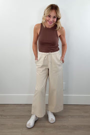 video of woman wearing beige wideleg trackpants