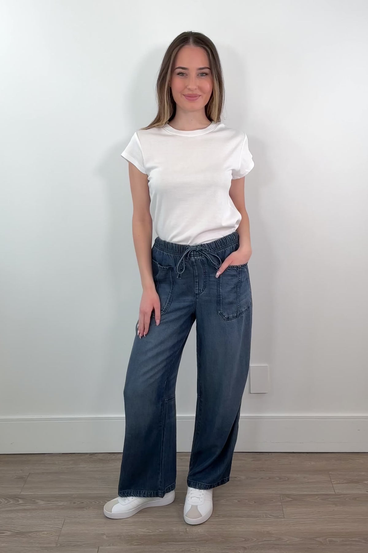 video of a woman wearing an ankle length blue tencel denim wide leg pants