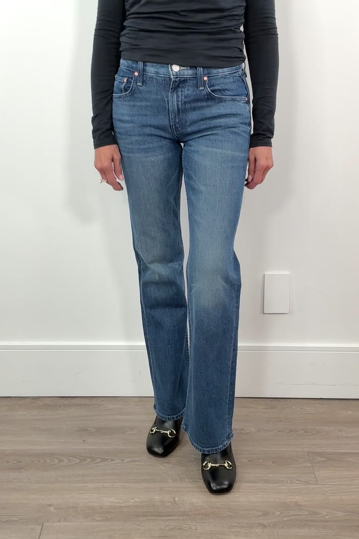 video of a woman wearing straight leg boot cut blue jeans