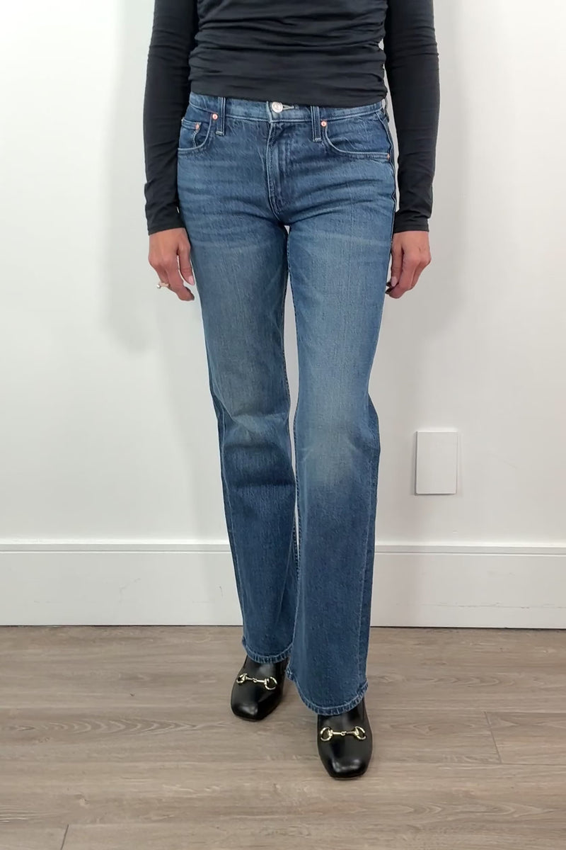 video of a woman wearing straight leg boot cut blue jeans