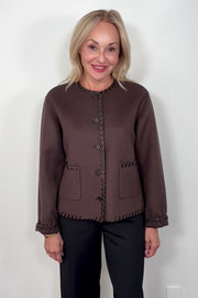 Video of woman wearing a brown wool coat with whipstitch detailing