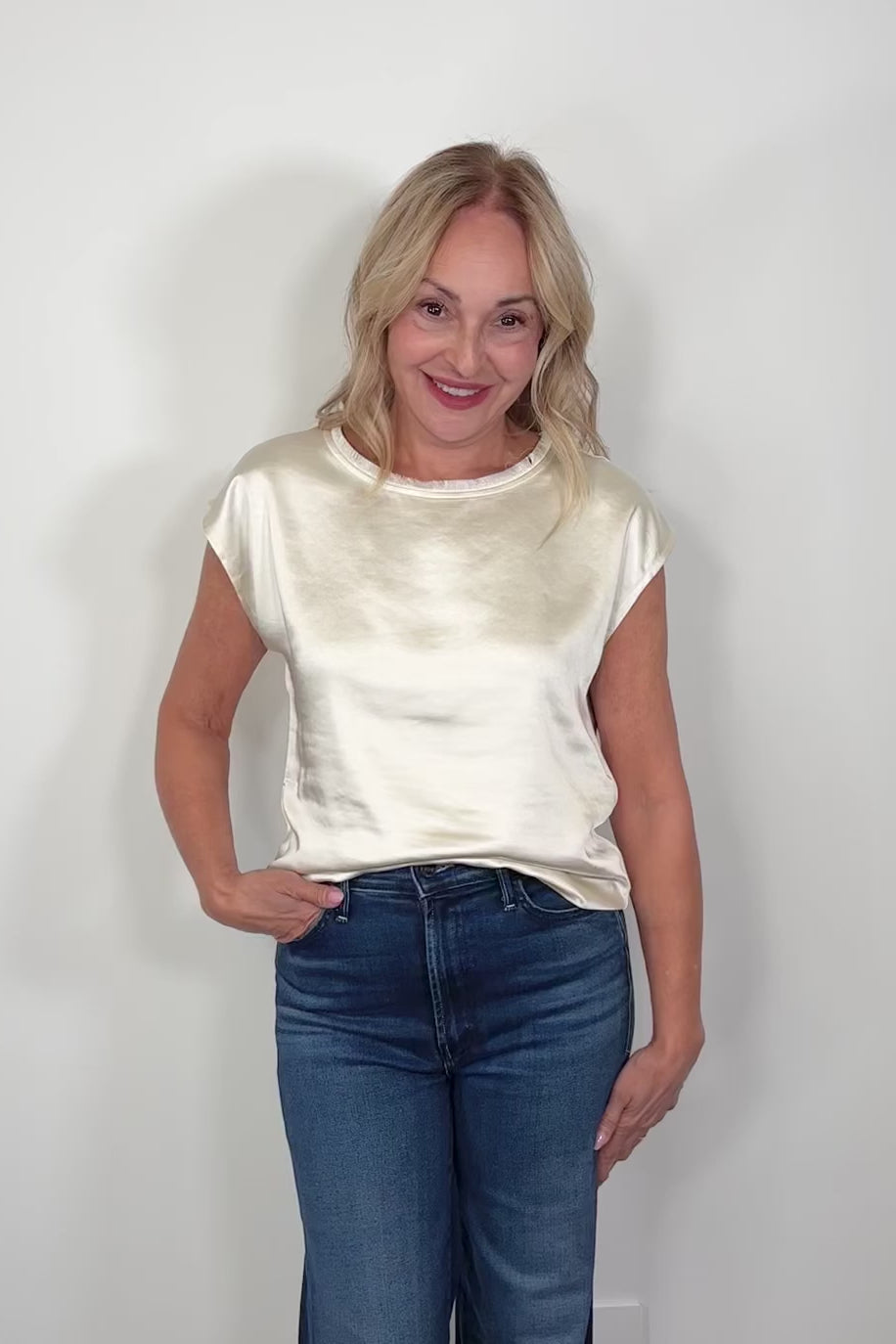 Video of a woman wearing a pearl satin cap sleeve tee