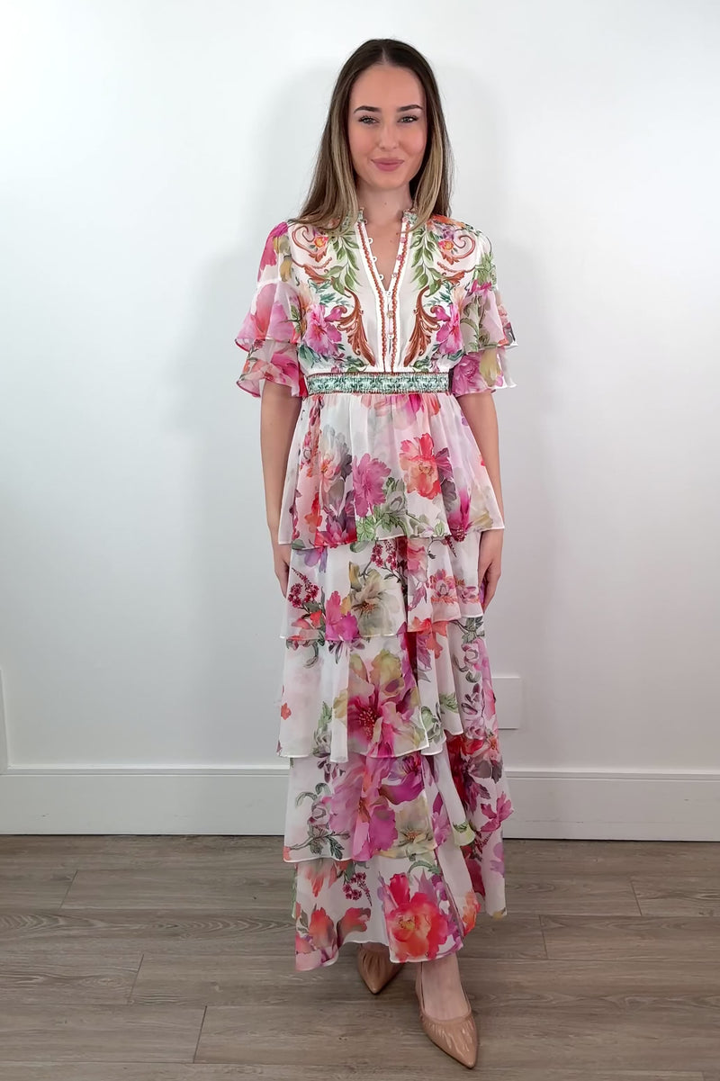 video of a woman wearing a floral tiered dress 