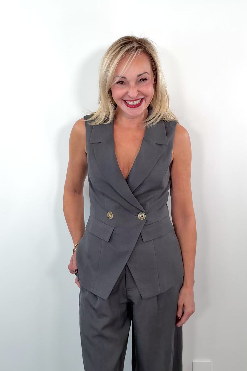 Video of Woman wearing a grey vest with button detail