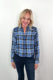 video of a woman wearing a blue plaid shirt with snap buttons